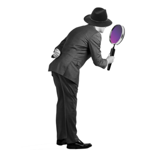 Man bending over looking through a large magnifying glass