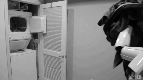 A stormtrooper failing to put laundry in a washing machine