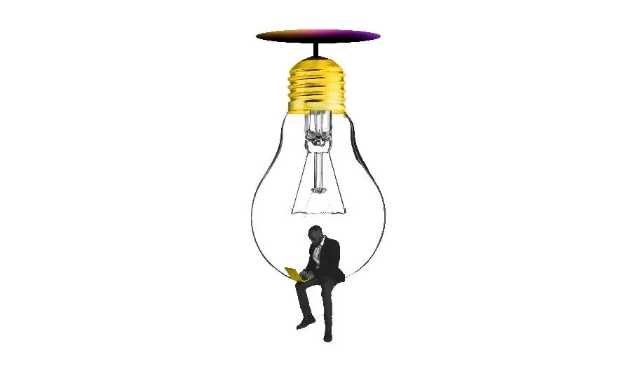 Branded image with a businessman on a laptop, perched in a lightbulb