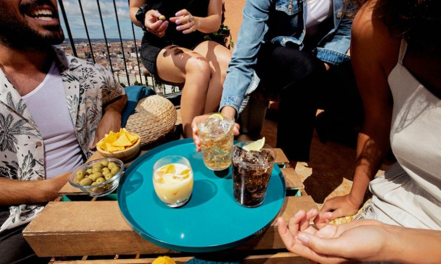 A patio party where people are enjoying cocktails