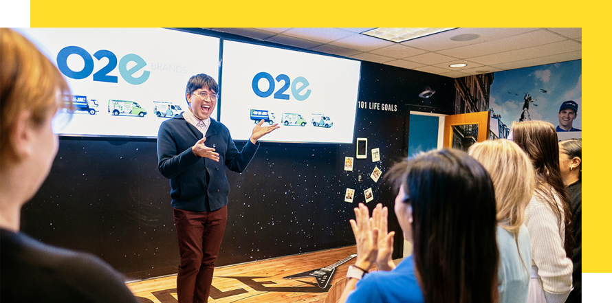 An image of O2E employees at the brand launch.