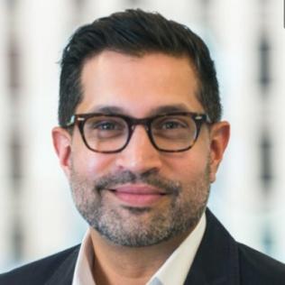 Headshot of Sameer Kazi wearing glasses and smiling