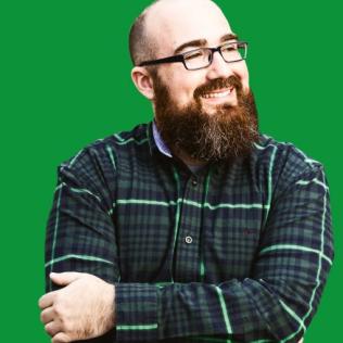 Image of Jim against a green background. Jim is wearing a plaid shirt.
